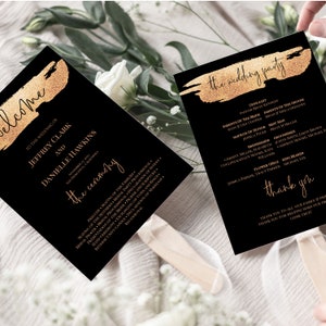 May include: Black and gold wedding program with a gold brushstroke design. The program includes the names of the wedding party and the ceremony order. The text "the wedding party" and "thank you" are written in a gold script font.