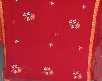 Könnte beinhalten: Ein roter Chiffon-Schal mit weißer und orangefarbener Blumenstickerei. Der Schal hat einen goldenen und orangenen Saum.