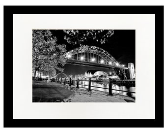 Autumn Leaves, black and white mounted photograph of Newcastle Gateshead quayside. Tyne Bridge, Millennium Bridge at night.