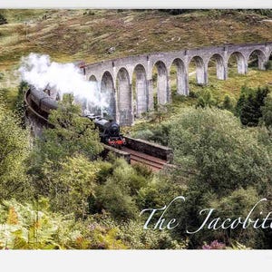 May include: A scenic image of a steam train crossing a stone viaduct. The train, emitting white smoke, is set against a backdrop of green foliage and rolling hills. The text "The Jacobite" is written in cursive at the bottom.