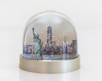 New York Snow Globe. Statue of Liberty and New York Skyline, Freedom Tower and Ice Skating in Central Park.