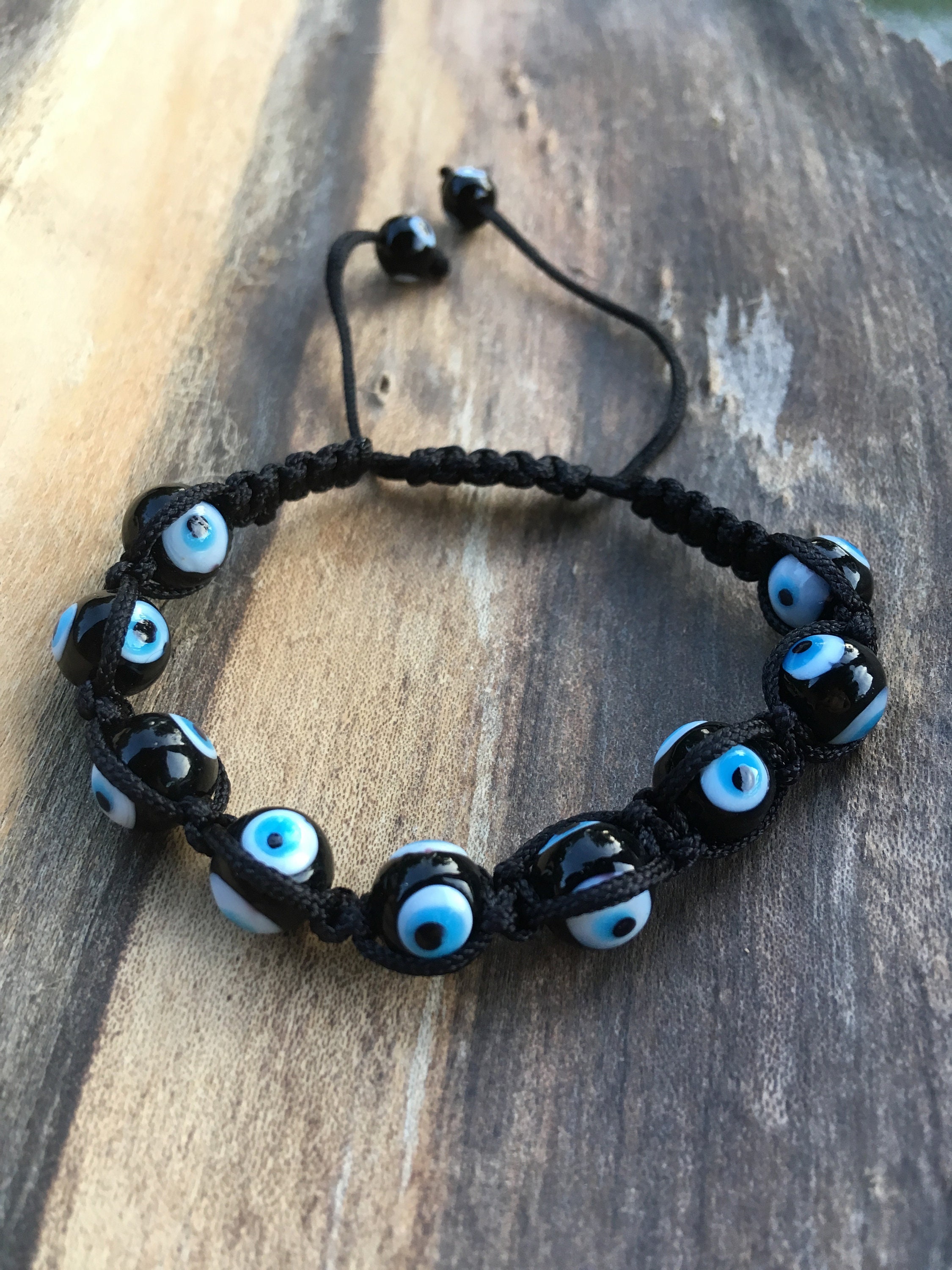 Blue evil eye with black a silver beads And black cord adjustable bracelet