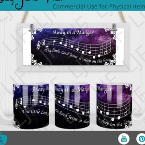 May include: Three white ceramic mugs with a celestial design featuring the text "Away in a Manger" and musical notes. The mugs have a dark blue and purple galaxy background. The image also includes a framed print with the same design.