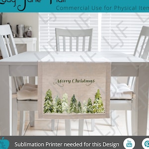 May include: A beige table runner with a watercolor design of green pine trees and the text "Merry Christmas".