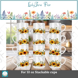 Pode incluir: Canecas brancas empilháveis com um design de girassol. Cada caneca apresenta um arranjo vibrante de girassóis amarelos com folhas verdes. As canecas são rotuladas como "For 10 oz Stackable cups" e a faixa superior diz "LadyJane Flair".