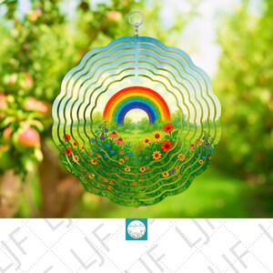 May include: A round, layered metal wind spinner featuring a colorful rainbow over a field of flowers. The outer layers have a wavy design with a blue sky background. The artwork includes red, yellow, and purple flowers.