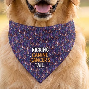 May include: A golden retriever wearing a dark purple triangular pet bandana featuring a repeating pattern of small colorful bones and paw prints with the text KICKING CANINE CANCER'S TAIL! printed in white and orange lettering on the front.
