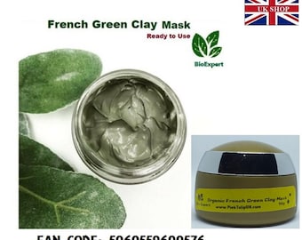May include: A green clay face mask in a glass jar with a silver lid. The jar is sitting on a green leaf. The product label says "Organic French Green Clay Mask" and "BioExpert".
