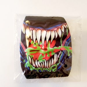 May include: A black face mask with a colorful graphic of a monster's open mouth with sharp teeth and a dripping tongue.