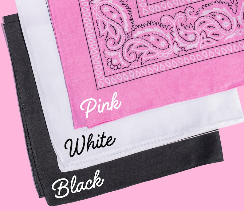May include: Three bandanas stacked on top of each other. The top bandana is pink with a white paisley pattern. The middle bandana is white. The bottom bandana is black. The bandanas are labeled "Pink", "White", and "Black" in white text.