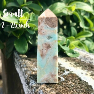 May include: A small, light blue and brown, polished, crystal point. The point is approximately 2-2.5 inches tall.  Small 2-2.5 inch