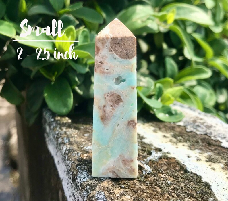 May include: A small, light blue and brown, polished, crystal point. The point is approximately 2-2.5 inches tall.  Small 2-2.5 inch