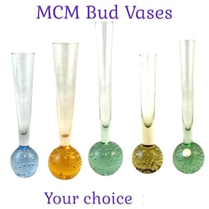 May include: Five clear glass bud vases with round, textured bases. The bases are in shades of blue, orange, green, yellow, and green. The vases are all different heights. MCM Bud Vases. Your choice.