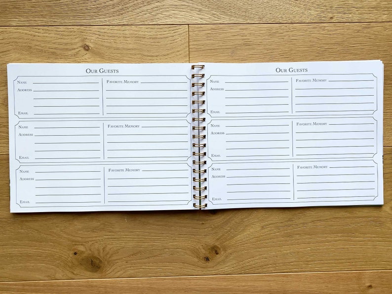 May include: A white guest book with a gold spiral binding. The book has two pages, each with the title "Our Guests" and spaces for names, addresses, emails, and favorite memories.
