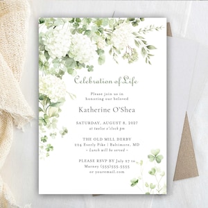 May include: A white invitation card with the text "Celebration of Life" and details for Katherine O'Shea's memorial service. The card is decorated with watercolor illustrations of white hydrangeas and green foliage.