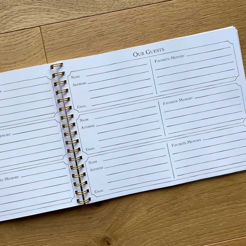 May include: A white spiral bound guest book with the title "Our Guests" printed at the top. The book has spaces for guests to write their names, addresses, emails, and favorite memories.