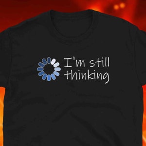 May include: Black t-shirt with a blue loading circle graphic and the text "I'm still thinking".
