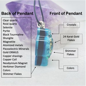 May include: A side view of a blue and black resin pendant on a black cord. The pendant features embedded 24 karat gold flakes, shimmer flakes, and various crystals. Text labels identify components like clear quartz, rose quartz, and copper coils.