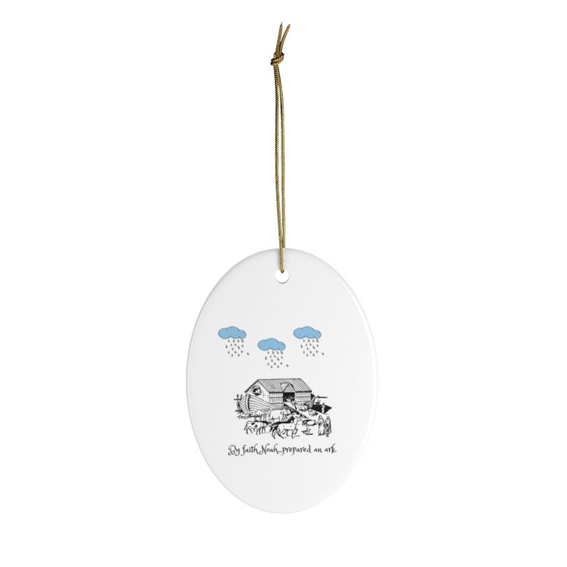 May include: A white oval ceramic ornament with a black and white illustration of Noah's Ark with animals and people. The text "By faith Noah prepared an ark" is written below the ark. Three blue clouds with rain are above the ark.