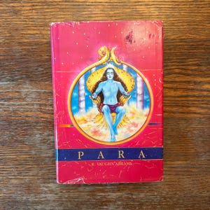 May include: A red book with a colorful illustration of a person sitting on a throne. The book title is "PARA" and the author is "R. VAUGHN ABRAMS".