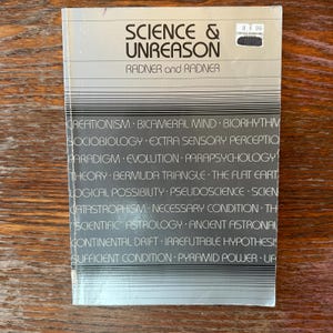 May include: A book titled "SCIENCE & UNREASON" by Radner and Radner. The cover is light gray with the title in large, bold, black letters. The book lists topics such as Creationism, Bermuda Triangle, and Pyramid Power.