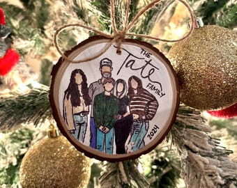 May include: A wooden Christmas tree ornament with a family portrait illustration. The ornament is round, with a natural wood grain edge, and features a family of five with the text "The Tate Family 2024". The ornament hangs from a twine loop.