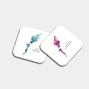 May include: Two square coasters with watercolor map designs. One coaster features a blue and teal map, the other a pink and purple map. Both have the text "THE OUTER HEBRIDES" in black.