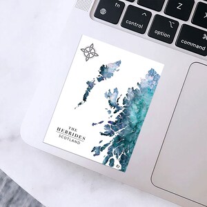 May include: A white sticker featuring a watercolor map of The Hebrides, Scotland, in shades of blue and teal. The sticker includes the text "THE HEBRIDES SCOTLAND" and a Celtic knot symbol. The sticker is placed on a laptop.