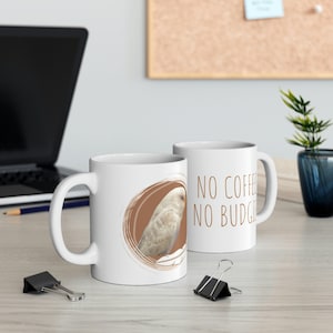 May include: Two white ceramic mugs with a brown circle design and a white budgie bird. The mug on the right has the text "NO COFFEE NO BUDGIE" printed on it.