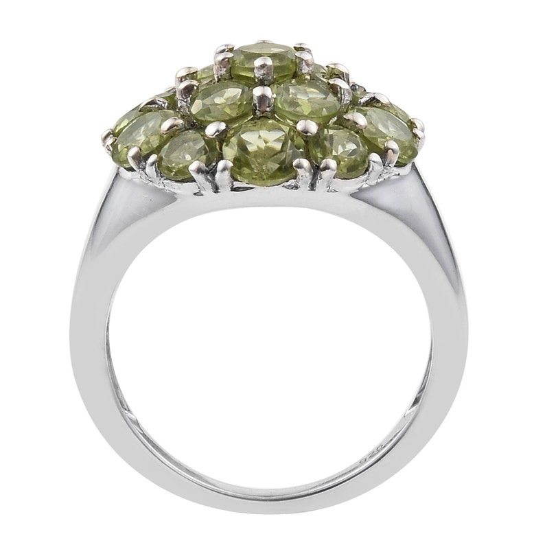 Silver Sterling Green Olivine Ring Holding Peridot Gems And Finished With Rhodium.