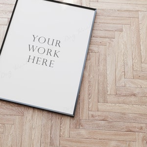May include: A black framed poster with a white background and the text "YOUR WORK HERE" in grey.