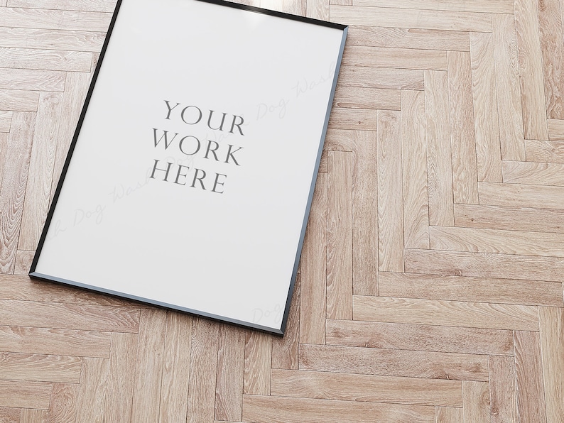 May include: A black framed poster with a white background and the text "YOUR WORK HERE" in grey.