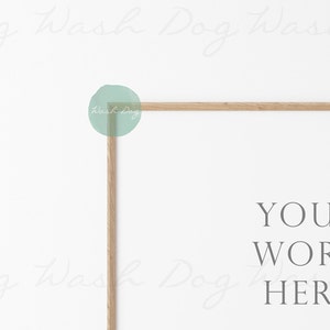May include: A white background with a light wood frame. The frame is in the shape of a rectangle and is positioned in the upper right corner of the image. The text "YOUR WORK HERE" is written in gray text below the frame.