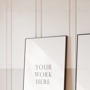 May include: Two black framed posters with white backgrounds. The text "YOUR WORK HERE" is on the left poster and "YOUR WORK HERE" is on the right poster.
