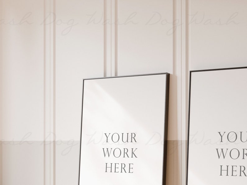 May include: Two black framed posters with white backgrounds. The text "YOUR WORK HERE" is on the left poster and "YOUR WORK HERE" is on the right poster.