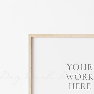 May include: A simple wooden frame with a white background and the text "YOUR WORK HERE" in the center.