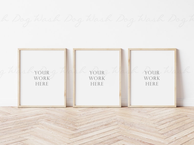 May include: Three wooden picture frames with white mats and the text "YOUR WORK HERE" in each frame. The frames are on a light wood floor.