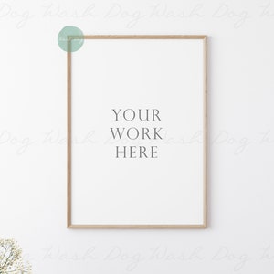 May include: A simple, light wood frame with a white mat and a white background. The text "YOUR WORK HERE" is printed in black in the center of the frame.