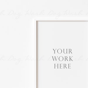 May include: White picture frame with a white mat and the text "YOUR WORK HERE" in the center.