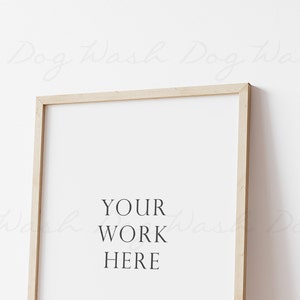 May include: A light wood frame with a white background and the text "YOUR WORK HERE" in black.