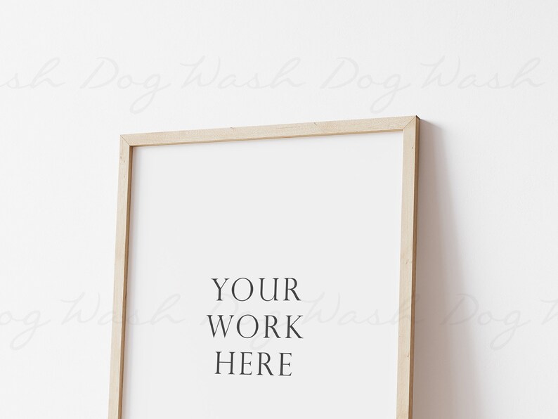 May include: A light wood frame with a white background and the text "YOUR WORK HERE" in black.