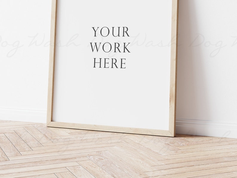 May include: A simple wooden frame with a white background and the text "YOUR WORK HERE" in black.