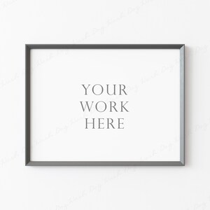 May include: A silver picture frame with a white mat and the text "YOUR WORK HERE" on a white wall.