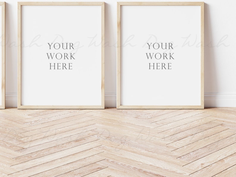 May include: Two light wood picture frames with white mats are hanging on a white wall. The frames are empty and ready for your artwork.