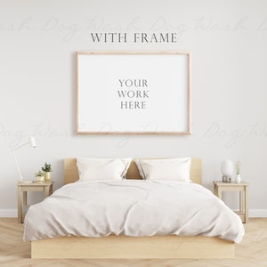 Op de afbeelding: Een wit bed met een houten frame en witte beddengoed. Een houten frame met een witte passe-partout en een licht houten frame omringt een lege witte ruimte met de tekst "YOUR WORK HERE".
