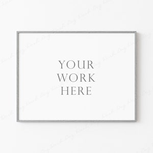 May include: A white frame with a silver border, hanging on a white wall. The frame is empty, with the text "YOUR WORK HERE" printed in the center.
