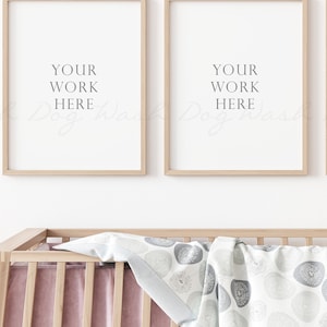 May include: Three wooden picture frames with white mats and a white background. The frames are hanging on a white wall above a wooden crib with a pink and white blanket. The text "YOUR WORK HERE" is printed in the center of each frame.