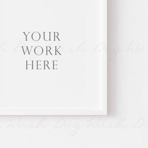 May include: A white square picture frame with the text "YOUR WORK HERE" in gray. The frame is set against a white background, creating a clean and minimalist aesthetic. Ideal for showcasing artwork or photography.