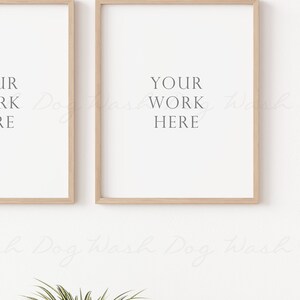 May include: Two wooden framed prints with the text "YOUR WORK HERE" on a white wall.