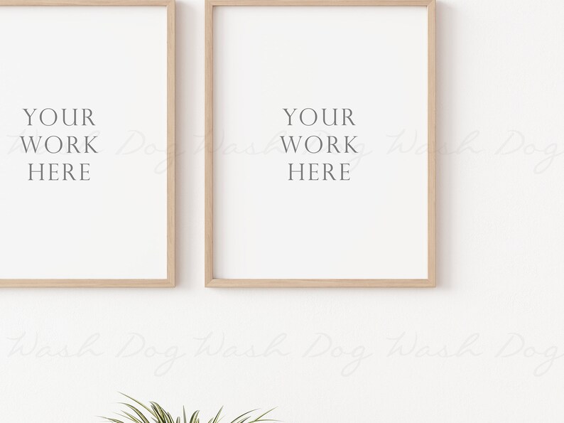 May include: Two wooden framed prints with the text "YOUR WORK HERE" on a white wall.
